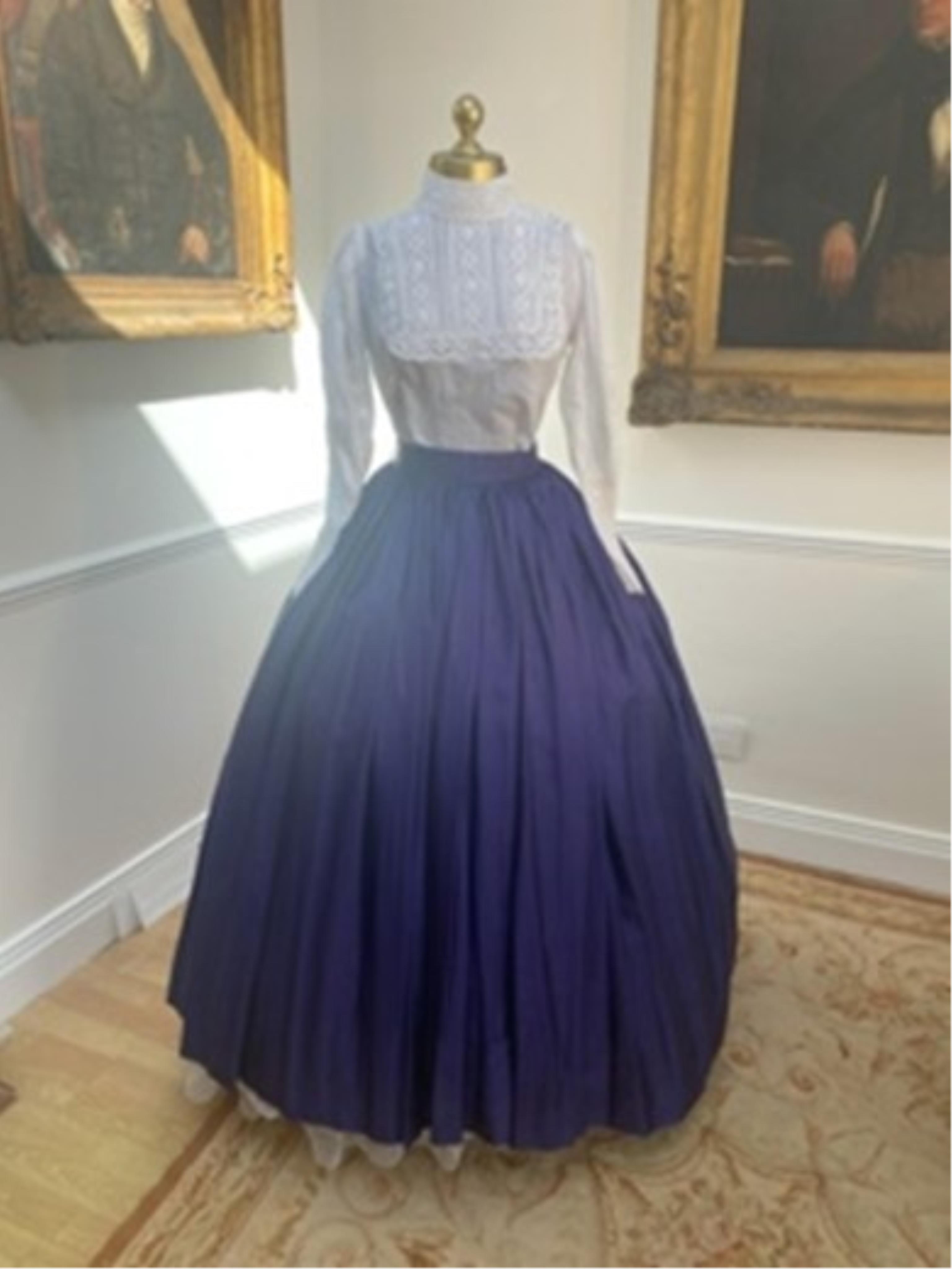 A Victorian style full skirt in peacock blue taffeta with white blouse and lace trim. Size Small/Medium.